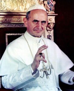 portrait of Pope Paul VI extending a blessing and seated