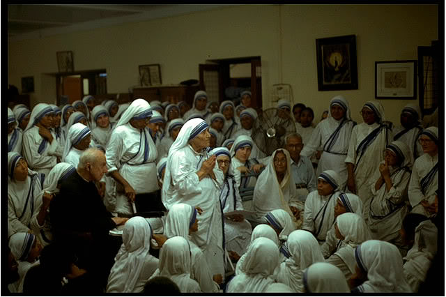 Father Hardon sitting with the Missionaries of Charity