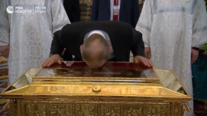 Screen capture of Vladimir Putin kissing the relics of St. Nicholas