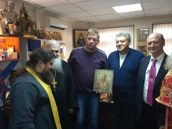 colonel presenting the dolphin delivered icon of The Sign