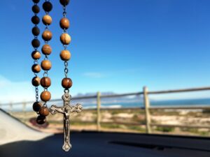 selective focus photo of brown and silver rosary